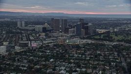 7.6K aerial stock footage flying by Waldorf Astoria and Beverly Hilton toward office buildings, twilight, Century City, California Aerial Stock Footage | AX0158_023E