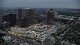 7.6K aerial stock footage passing by office buildings and shopping mall, twilight, Century City, California Aerial Stock Footage | AX0158_025