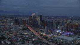7.6K aerial stock footage orbiting Downtown Los Angeles skyscrapers, Interstate 110 and Staples Center at twilight, California Aerial Stock Footage | AX0158_045E