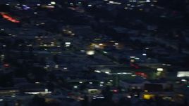 7.6K aerial stock footage of an LAPD helicopter flying over city buildings at twilight in Los Angeles, California Aerial Stock Footage | AX0158_062E