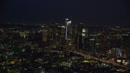 7.6K aerial stock footage of 110 traffic by skyscrapers and Staples Center at night, Downtown Los Angeles, California Aerial Stock Footage | AX0158_090E