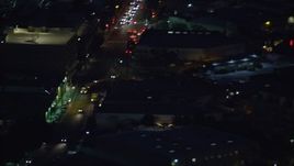 7.6K aerial stock footage of an LAPD helicopter flying over Downtown Los Angeles, California at night Aerial Stock Footage | AX0158_099