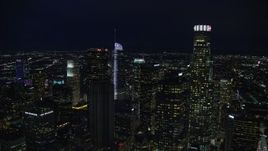 7.6K aerial stock footage of Aon Center to reveal Wilshire Grand Center at night, Downtown Los Angeles, California Aerial Stock Footage | AX0158_111E