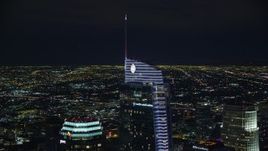 7.6K aerial stock footage orbiting the top of Wilshire Grand Center and reveal US Bank Tower at night, Downtown Los Angeles, California Aerial Stock Footage | AX0158_115E