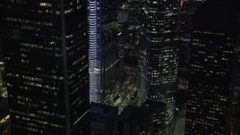 7.6K aerial stock footage of a view of the base of Wilshire Grand Center at night in Downtown Los Angeles, California Aerial Stock Footage | AX0158_117E
