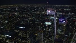 7.6K aerial stock footage orbiting and tilt to a bird's eye of Wilshire Grand Center in Downtown Los Angeles, California at night Aerial Stock Footage | AX0158_121E