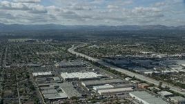7.6K aerial stock footage flying over the 118 freeway and warehouses, Pacoima, San Fernando Valley, California Aerial Stock Footage | AX0159_002