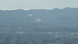 7.6K aerial stock footage tracking a Cessna flying over San Fernando Valley, cloudy, California Aerial Stock Footage | AX0159_003