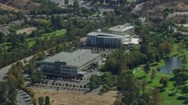 7.6K aerial stock footage orbiting office buildings next to a golf course, Valencia, California Aerial Stock Footage | AX0159_032
