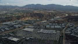 7.6K aerial stock footage of a road and warehouses, Santa Clarita, California Aerial Stock Footage | AX0159_048E
