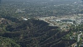 7.6K aerial stock footage approaching JPL from behind a mountain ridge, Pasadena, California Aerial Stock Footage | AX0159_066