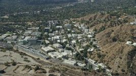 7.6K aerial stock footage flying over JPL facility toward neighboring suburban houses; Pasadena, California Aerial Stock Footage | AX0159_083E