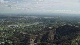 7.6K aerial stock footage flying over hilltop toward residential neighborhoods below, Pasadena, California Aerial Stock Footage | AX0159_092