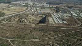 7.6K aerial stock footage of an open pit next to a brewery in Irwindale, California Aerial Stock Footage | AX0159_125