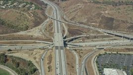 7.6K aerial stock footage of a reverse view of the I-10 / Hwy 57 / Hwy 71 Interchange in Pamona, California Aerial Stock Footage | AX0159_133