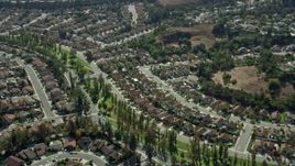 7.6K aerial stock footage flying by tract homes in a peaceful neighborhood in Pamona, California Aerial Stock Footage | AX0159_134