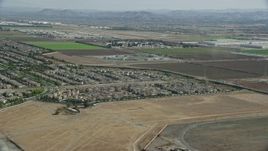 7.6K aerial stock footage flying over tract homes towards the East Yard of CIM Prison (California Institution for Men), Chino, California Aerial Stock Footage | AX0159_139E