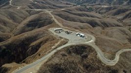 7.6K aerial stock footage flying over storage facility in the hills near dirt trails, Chino Hills State Park, California Aerial Stock Footage | AX0159_154