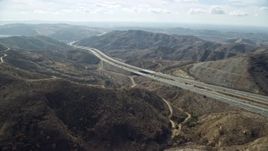 7.6K aerial stock footage following a freeway through the hills, Anaheim, California Aerial Stock Footage | AX0159_158E