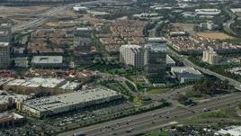 7.6K aerial stock footage of office buildings and shopping mall along a freeway, Irvine, California Aerial Stock Footage | AX0159_168E