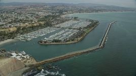 7.6K aerial stock footage flying over boats at Dana Point Harbor, and approach the shore in Dana Point, California Aerial Stock Footage | AX0159_192E