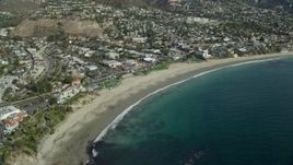 7.6K aerial stock footage orbiting business and houses near the beach, Laguna Beach, California Aerial Stock Footage | AX0159_220E