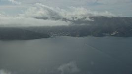 7.6K aerial stock footage of low clouds over the island town of Avalon, Catalina Island, California Aerial Stock Footage | AX0159_246