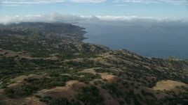 7.6K aerial stock footage flying over hills toward the coast of Santa Catalina Island, California Aerial Stock Footage | AX0160_001