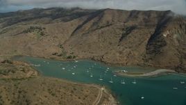7.6K aerial stock footage of fly over hills toward sailboats in Catalina Harbor in Two Harbors, Santa Catalina Island, California Aerial Stock Footage | AX0160_012E