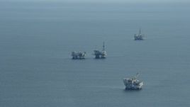 7.6K aerial stock footage of oceanic oil rigs off the coast of Southern California Aerial Stock Footage | AX0160_033