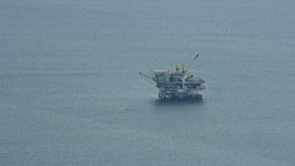 7.6K aerial stock footage flying by an oceanic oil rig off the coast of Southern California Aerial Stock Footage | AX0160_034