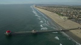 7.6K aerial stock footage of Huntington Beach Pier and the beach in Huntington Beach, California Aerial Stock Footage | AX0160_041E