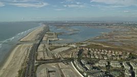 7.6K aerial stock footage flying over Hwy 1 and beach to Bolsa Chica Basin State Marine Conservation Area, Huntington Beach, California Aerial Stock Footage | AX0160_046