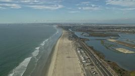7.6K aerial stock footage of Hwy 1 and Bolsa Chica Basin State Marine Conservation Area, Huntington Beach, California Aerial Stock Footage | AX0160_047E