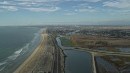 7.6K aerial stock footage of the beach and Hwy 1 by Bolsa Chica State Marine Conservation Area, Huntington Beach, California Aerial Stock Footage | AX0160_049