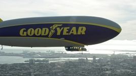 7.6K aerial stock footage of the Goodyear Blimp flying over Long Beach, California Aerial Stock Footage | AX0160_064E