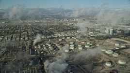 7.6K aerial stock footage flying over low level clouds to reveal the Chevron oil refinery in El Segundo, California Aerial Stock Footage | AX0161_042E