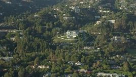 7.6K aerial stock footage flying by a large hillside mansion with manicured grounds in Beverly Hills, California Aerial Stock Footage | AX0161_108