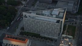 7.6K aerial stock footage orbiting LAPD headquarters at twilight in Downtown Los Angeles, California Aerial Stock Footage | AX0162_075E