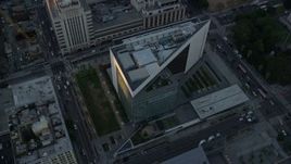 7.6K aerial stock footage of a reverse view of LAPD headquarters at twilight, revealing city hall in Downtown Los Angeles, California Aerial Stock Footage | AX0162_078