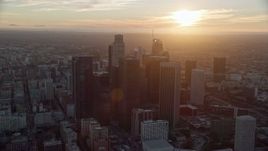 7.6K aerial stock footage of a reverse view of the tall towers of downtown at sunset in Downtown Los Angeles, California Aerial Stock Footage | AX0162_085E
