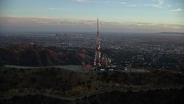 7.6K aerial stock footage orbiting the Hollywood Sign at twilight to reveal Downtown Los Angeles, California  Aerial Stock Footage | AX0162_103