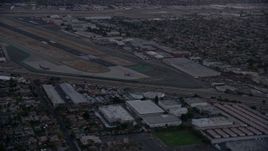 7.6K aerial stock footage of commercial airplanes on the end of the runway at Burbank Airport, California, twilight Aerial Stock Footage | AX0162_115