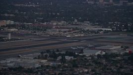 7.6K aerial stock footage of a commercial airplane taking off at twilight from Burbank Airport, California Aerial Stock Footage | AX0162_117E
