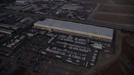 7.6K aerial stock footage approaching and passing a large warehouse building in Pacoima, California at twilight Aerial Stock Footage | AX0162_119