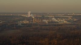 4K aerial stock footage of flying by an oil refinery at sunset in Romeoville, Illinois Aerial Stock Footage | AX0163_0001