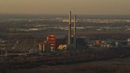 4K aerial stock footage of flying by a coal-fired power plant at sunset in Romeoville, Illinois Aerial Stock Footage | AX0163_0002