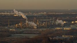 4K aerial stock footage of passing by an oil refinery at sunset in Romeoville, Illinois Aerial Stock Footage | AX0163_0003