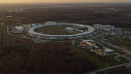 4K aerial stock footage of flying by the Advanced Photon Source at the Argonne National Laboratory at sunset in Lemont, Illinois Aerial Stock Footage | AX0163_0008