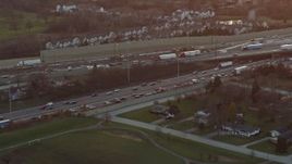 4K aerial stock footage a reverse view of heavy traffic on a freeway interchange at sunset in Burr Ridge, Illinois Aerial Stock Footage | AX0163_0013
